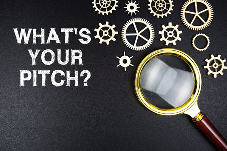 What's Your Pitch? text message with magnifying glass on black backgroundの写真素材
