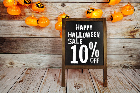 Halloween Sale 10% off text with LED pumpkin decoration on wooden backgroundの写真素材