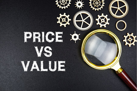 Price vs Value text message with magnifying glass on black backgroundの写真素材