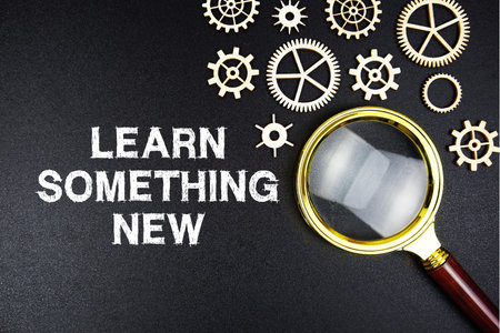 Learn Something New text message with magnifying glass on black background