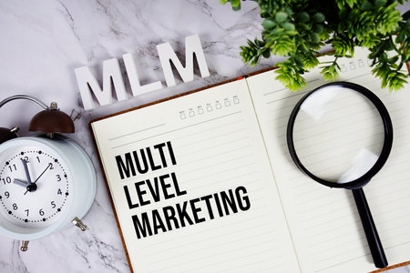 MLM - Multi Level Marketing acronym on notepad, Business concept backgroundの写真素材