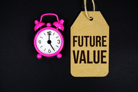 Future Value text on price tag with alarm clock on black backgroundの写真素材