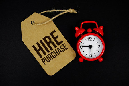 Hire Purchase text on price tag with alarm clock on black backgroundの写真素材