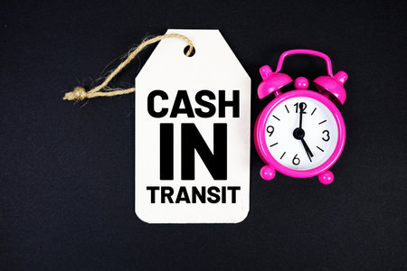Cash In Transit text on price tag with alarm clock on black backgroundの写真素材