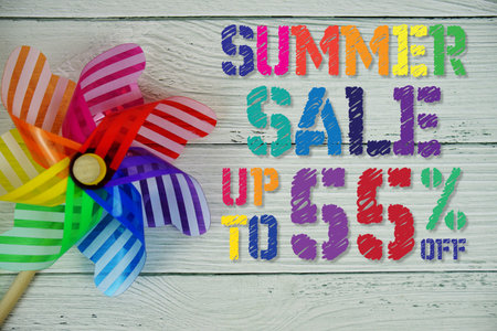 Summer Sale 55% off text with Colorful Windmill on wooden background