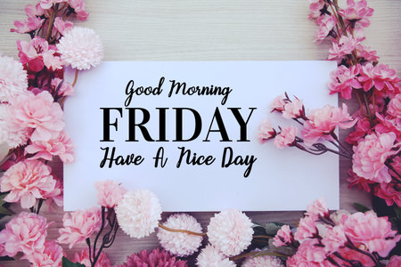 Good Morning Friday Have a nice day text with flowers decorations on wooden backgroundの写真素材