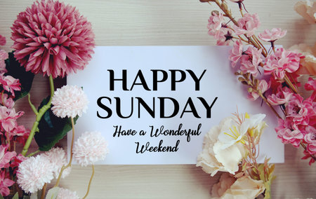 Happy Sunday Have a Wonderful Weekend text with flowers decorations on wooden backgroundの写真素材