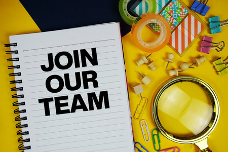 Join Our Team text with magnifying glass and stationery on yellow backgroundの写真素材