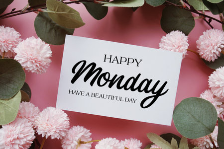 Happy Monday Have a Beautiful Day text with flowers decorations on pink backgroundの写真素材