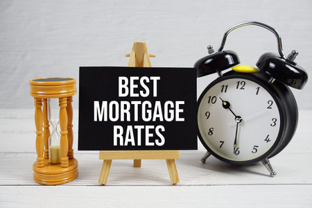 Best Mortgage Rates text with hourglass and alarm clock on wooden background