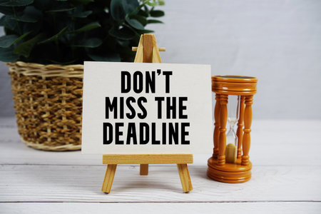 Don't Miss The Deadline text with hourglass on wooden backgroundの写真素材