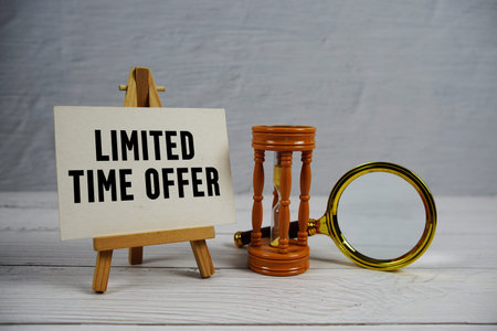 Limited Time Offer text with hourglass and magnifying glass on wooden background