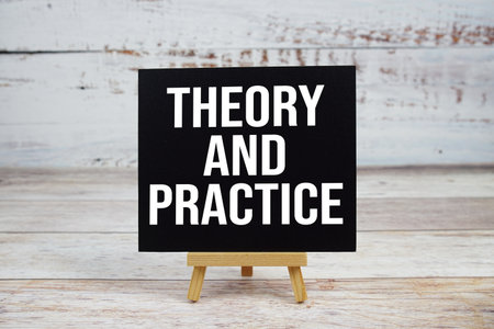 Theory And Practice text with easel on wooden backgroundの写真素材