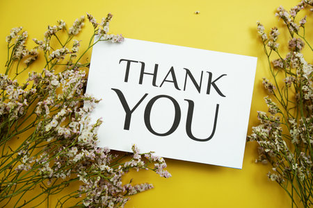 Thank You text message with flowers  on yellow backgroundの写真素材