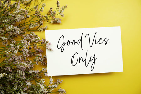 Good Vibes Only text with flowers decoration on yellow backgroundの写真素材