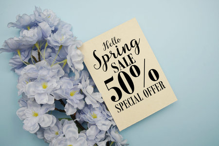 Spring Sale 50% Promotion and Marketing with flowers bouquet decoration on light blue background