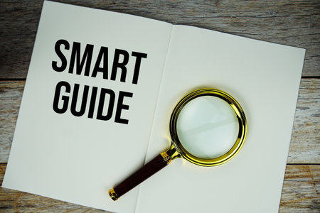 Smart Guide text written on paper with magnifying glass on wooden backgroundの写真素材