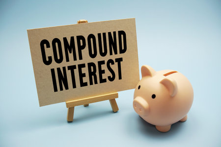 Compound Interest text and piggy bank for saving on blue backgroundの写真素材