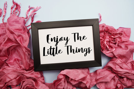 Enjoy The Little Things Motivational and Inspirational quotes on light blue backgroundの写真素材