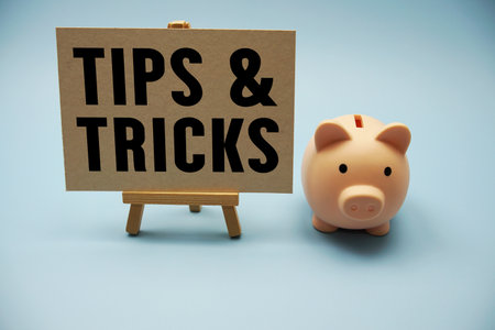 Tips And Tricks text and piggy bank for saving on blue backgroundの写真素材