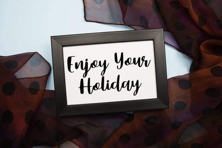 Enjoy Your Holiday Motivational and Inspirational quotes on light blue backgroundの写真素材