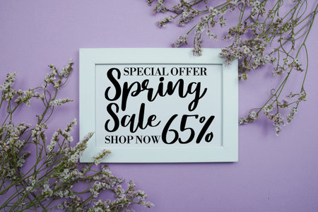 Spring Sale 65% Promotion and Marketing with flowers bouquet decoration on purple backgroundの写真素材