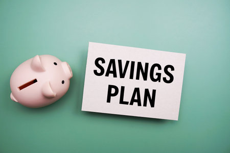 Savings Plan text and piggy bank for saving on green backgroundの写真素材