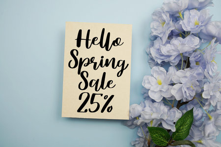 Spring Sale 25% Promotion and Marketing with flowers bouquet decoration on light blue backgroundの写真素材