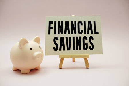 Financial Savings text and piggy bank for saving on pink backgroundの写真素材