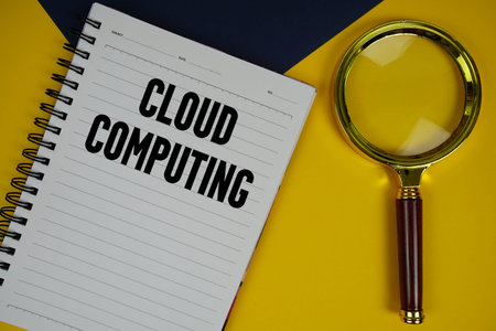 Cloud Computing text with magnifying glass on yellow backgroundの写真素材