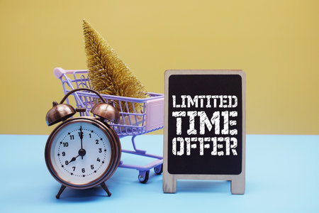 Limtited Time Offer Promotion and Marketing with alarm clock and mini trolley Shopping cartの写真素材