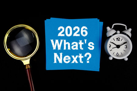 2026 What's Next? text with magnifying glass and alarm clock on black backgroundの写真素材
