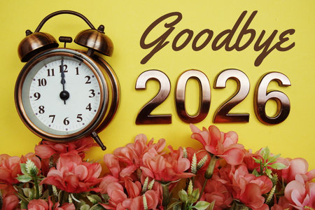 Goodbye 2026 text with alarmclock and flower decoration on yellow backgroundの写真素材