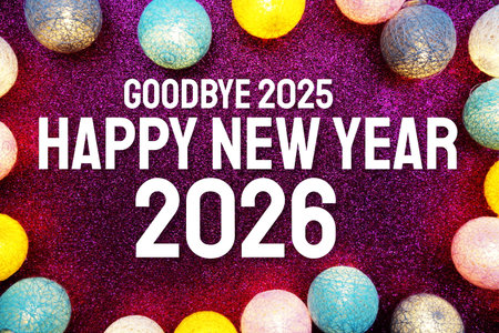 Happy New Year 2026 text and LED cotton balls decoration on pink glitter backgroundの写真素材