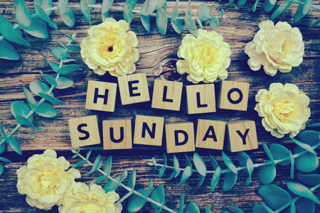 Hello Sunday alphabet letter and flower decorate on wooden backgroundの写真素材