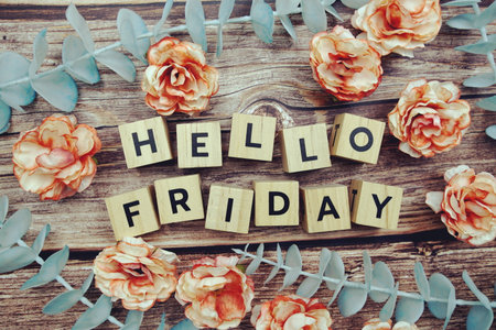 Hello Friday alphabet letter and flower decorate on wooden backgroundの写真素材