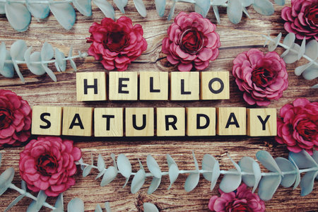Hello Saturday alphabet letter and flower decorate on wooden backgroundの写真素材