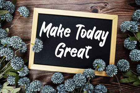 Make Today Great Motivational and Inspirational quotes text on blackboard with flowers decoration on wooden backgroundの写真素材