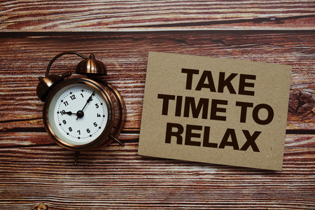 Time To Relax text with alarm clock on wooden backgroundの写真素材