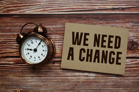 We need a change text with alarm clock on wooden background