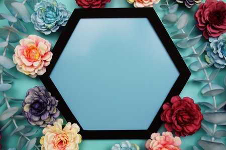 Blue Hexagon background and black border decorate with flowers on blue background