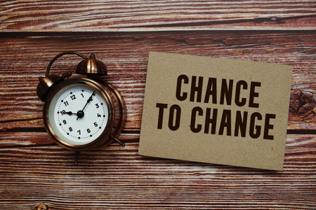 Chance To Change text with alarm clock on wooden background