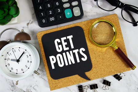 Get Points text with Calculator, alarm clock and magnifying glass on marble background