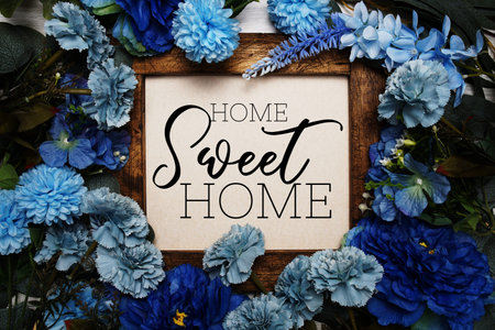 Home Sweet Home text with flowers bouquet decoration on wooen backgroundの写真素材