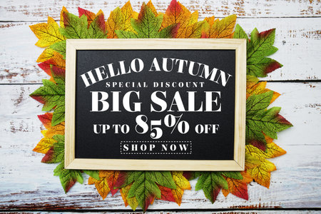 Hello Autumn Big Sale 85% with maple leaf decorated on wooden background