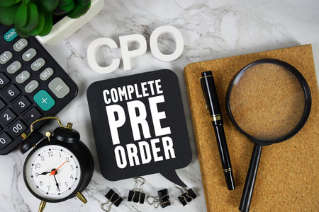 CPO Complete Pre-Order text with Calculator, alarm clock and magnifying glass on marble background