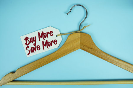 Buy More Save More text on price tag label with Clothes hanger fashion shopping concept