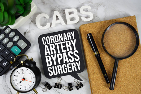 CABS Coronary Artery Bypass Surgery text with Calculator, alarm clock and magnifying glass on marble...