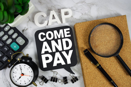 CAP Come And Pay text with Calculator, alarm clock and magnifying glass on marble background