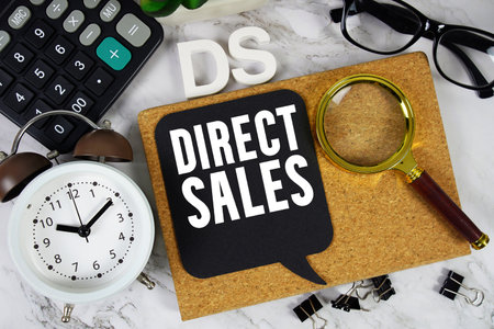 DS Direct Sales text with Calculator, alarm clock and magnifying glass on marble backgroundの写真素材